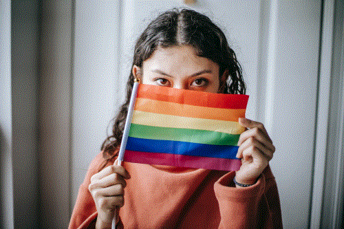 woman holding flag under her eyes 