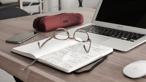 open laptop and glasses on notebook